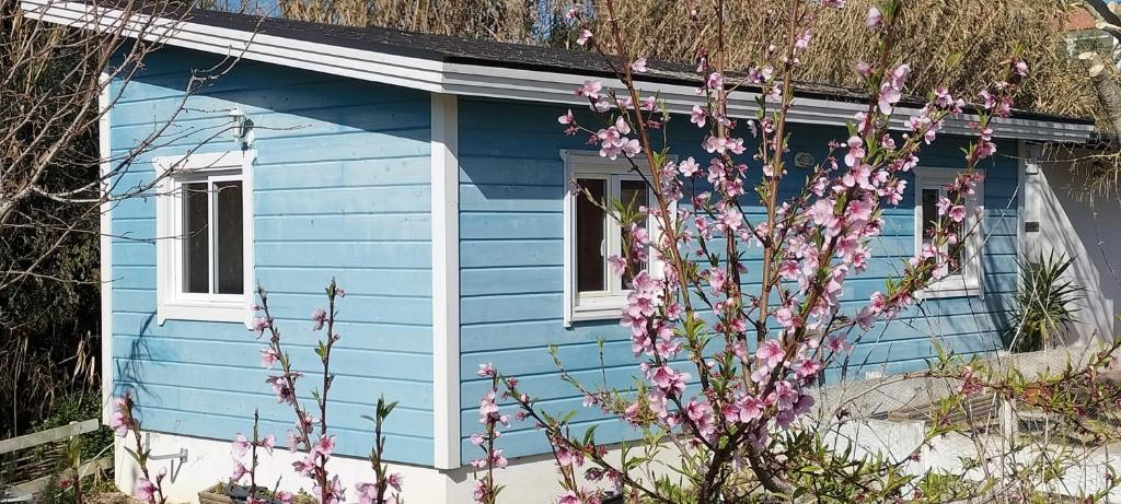 ein blaues Haus mit rosa Blumen davor in der Unterkunft Sintra Serenity in Sintra