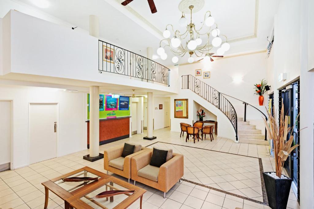 a living room with a couch and a table at Cairns Queens Court in Cairns