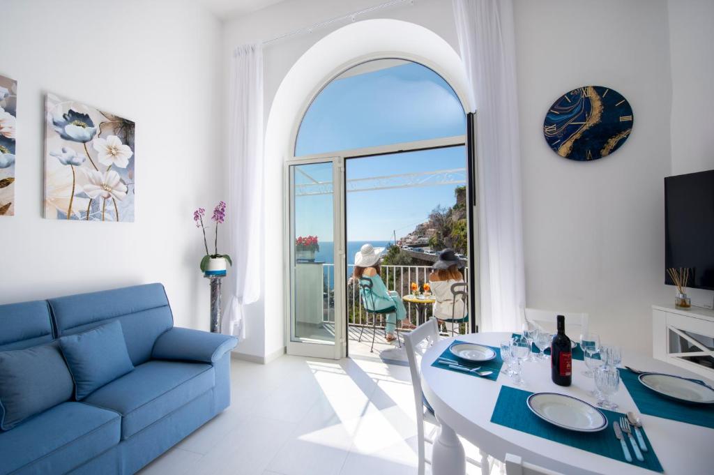 a living room with a blue couch and a table at Casa Carmela in Positano