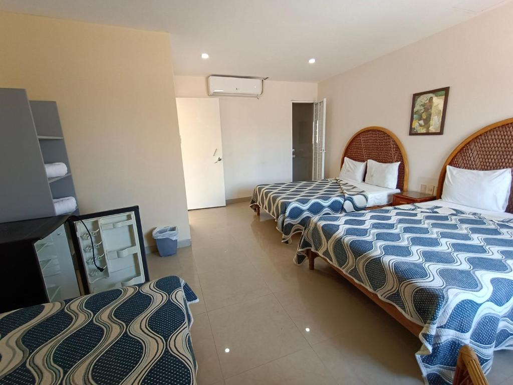 Postel nebo postele na pokoji v ubytování Hotel Playa de Oro - Enfrente de WTC y Plazas Comerciales