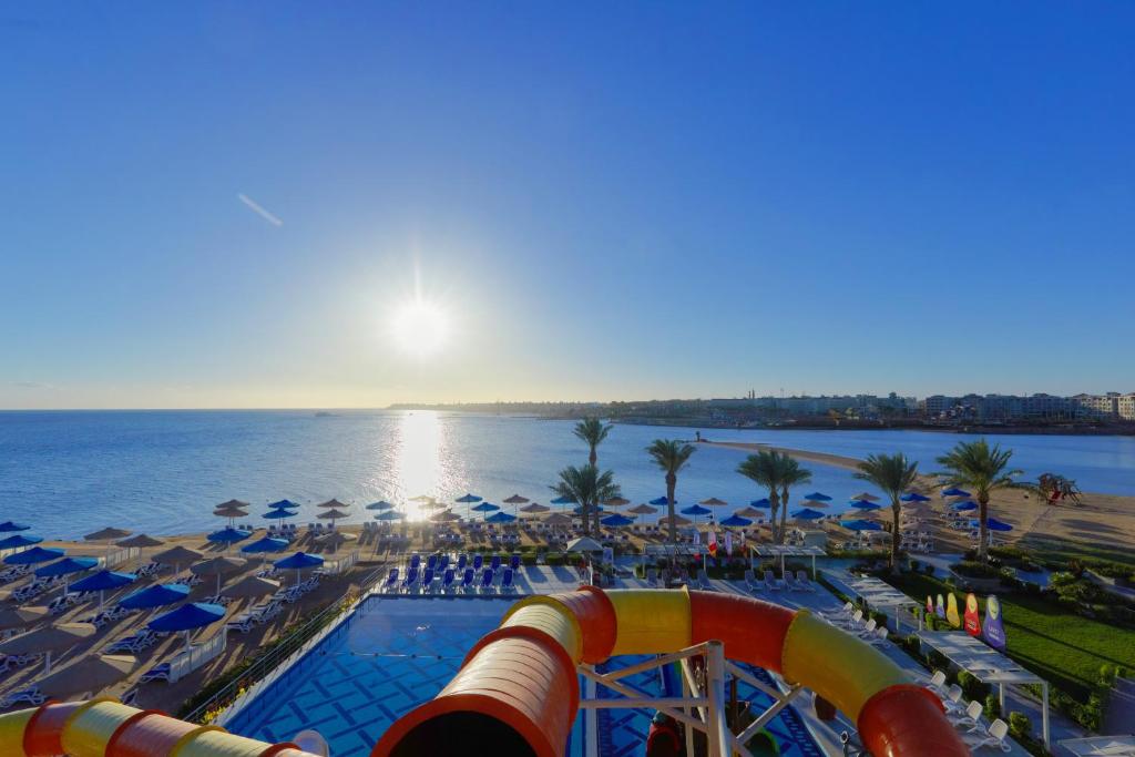 a view of a resort with a roller coaster and the ocean at Bellagio Beach Resort & Spa in Hurghada