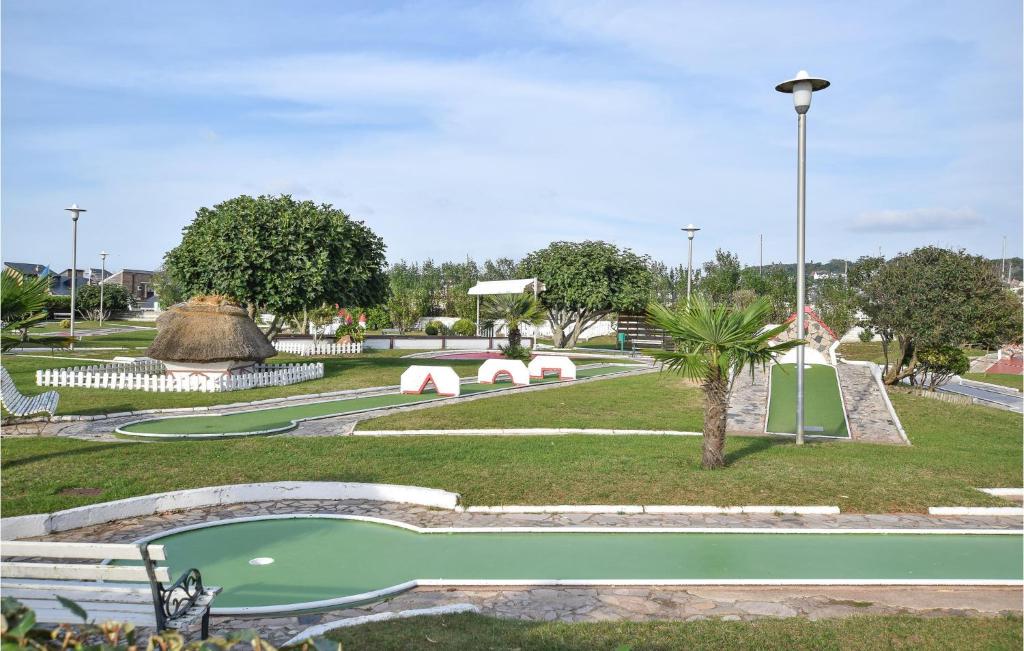 a park with a playground with a golf course at Awesome Apartment In quemauville With Outdoor Swimming Pool, Heated Swimming Pool And 1 Bedrooms in Équemauville