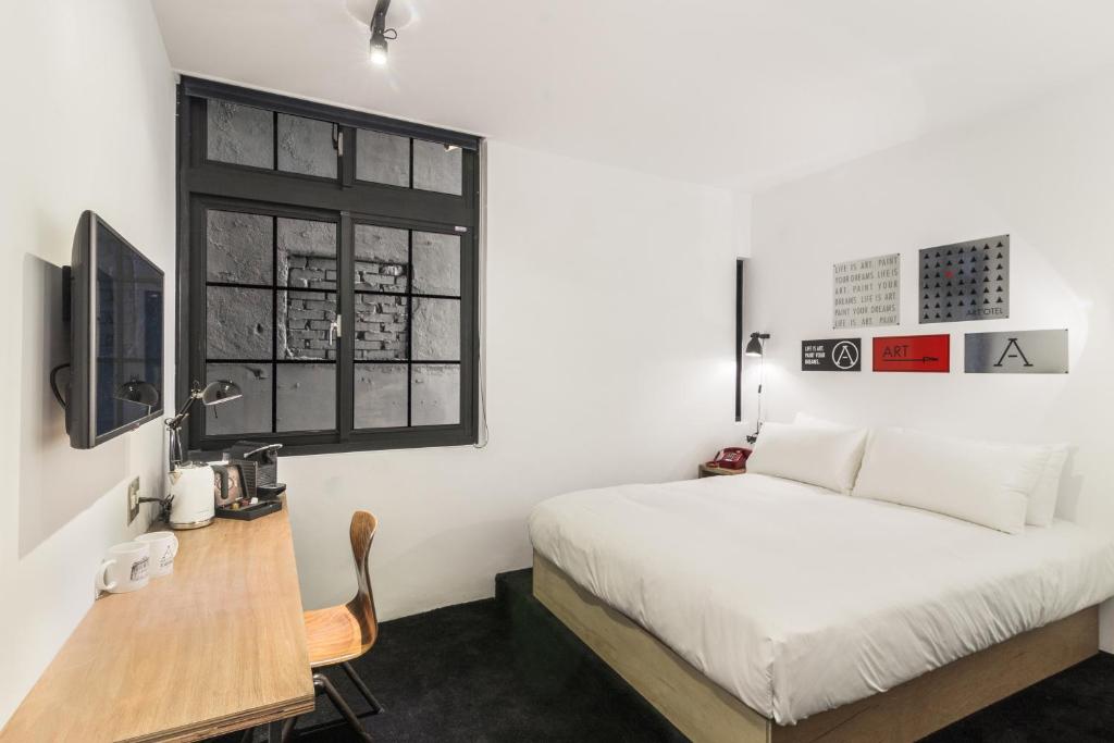 Postel nebo postele na pokoji v ubytování ART'OTEL Ximending TAIPEI