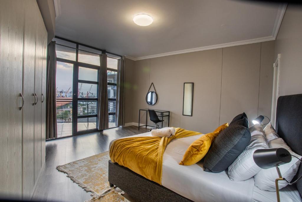 a bedroom with a large bed and a large window at Stay at The Point - Copper Cove in Durban