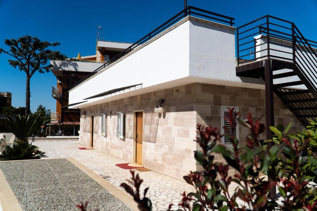 a house with a staircase on the side of it at Villa Eletti - A Due Passi dai Sassi e dal centro città in Matera