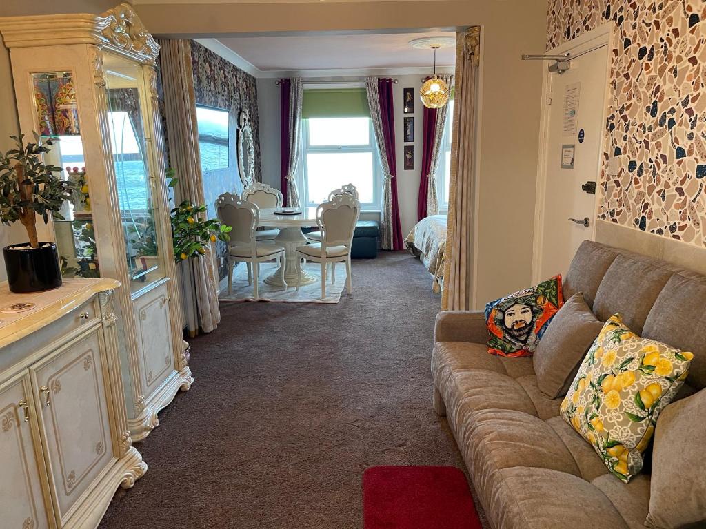 a living room with a couch and a table at "The Italian" Seafront Apartment in Eastbourne