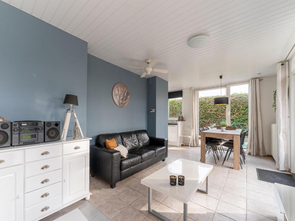 a living room with a couch and a table at Holiday Home in Zeeland near Lake in Baarland