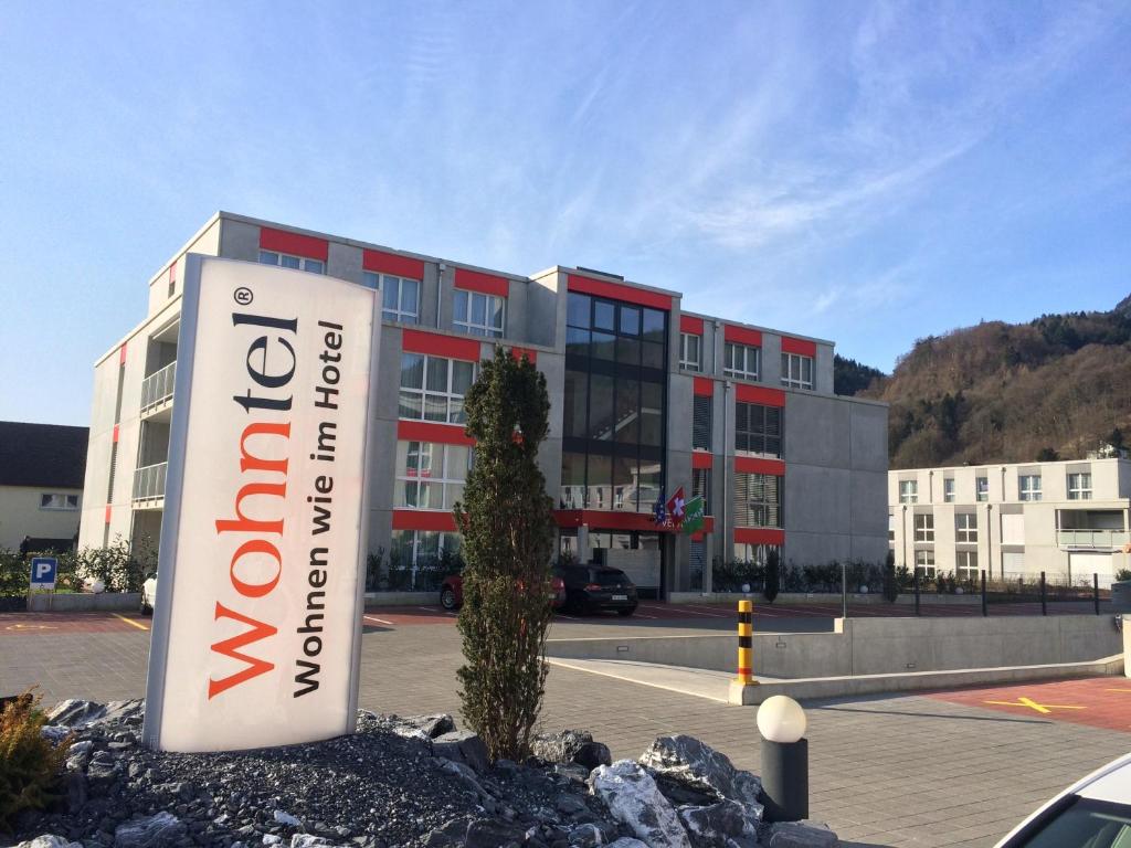 a building with a sign in front of it at Wohntel - wohnen wie im Hotel in Sevelen