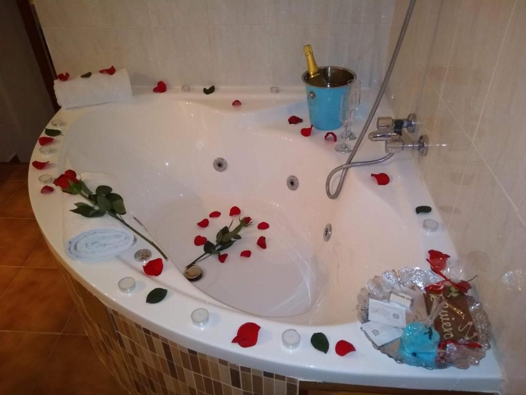 a bath tub filled with flowers in a bathroom at CASA CUEVA VANESA in Hinojares