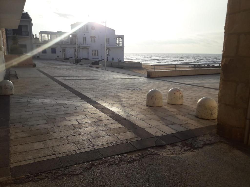 a view of a street with the ocean in the background at Casa Incanto Marina Bis in Marina di Ragusa