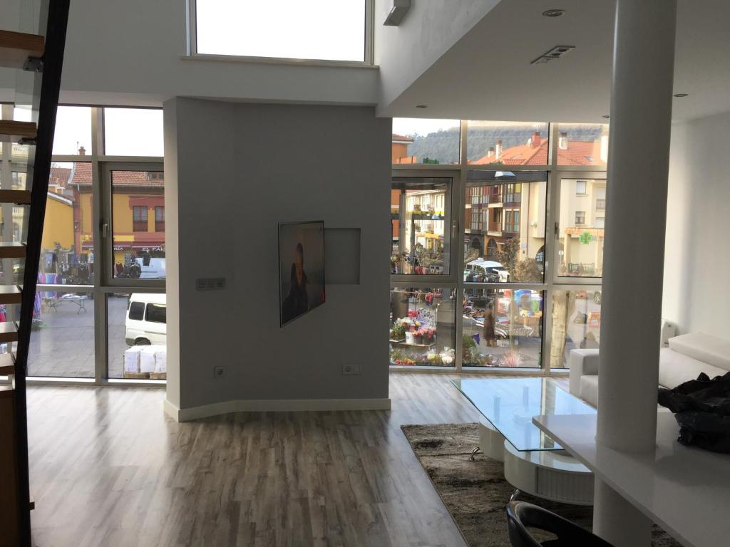 a living room with a table and some windows at Casa Marga in San Juan de la Arena