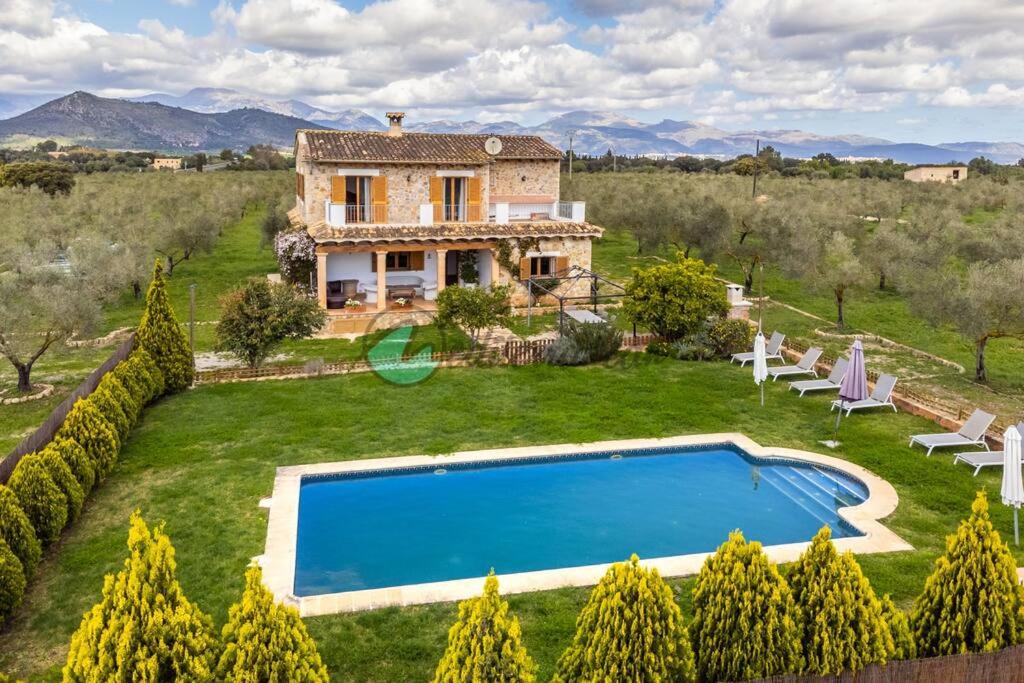 an external view of a villa with a swimming pool at Ecovilla ses oliveres by villasmediterranean in Llubí