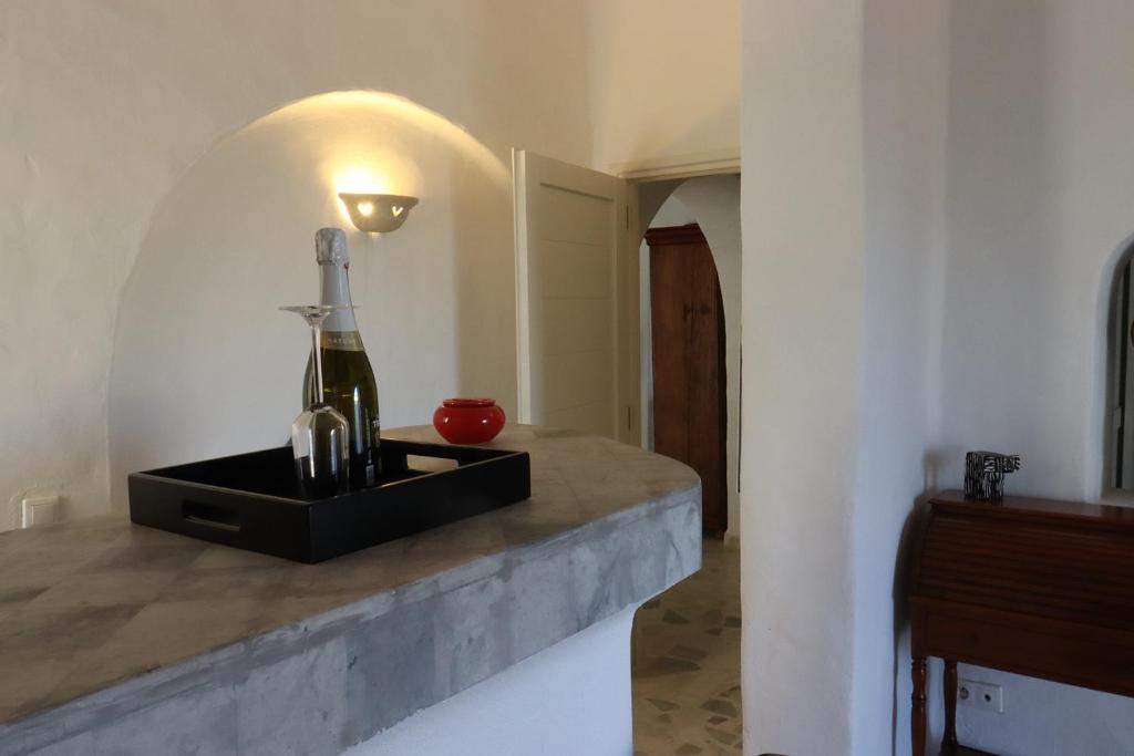 a bottle of wine on a counter in a room at Villa Naïa Domaine Béluga Bounouma kerkennah in Sfax