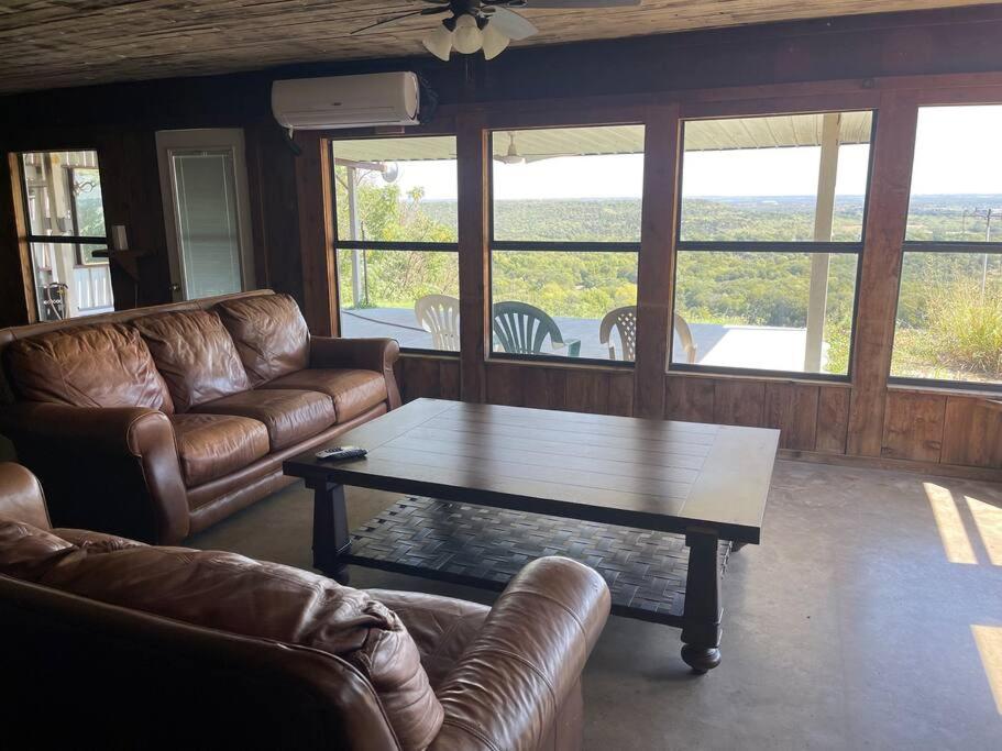 a living room with a couch and a coffee table at 4-bedroom home with gorgeous view in Mineral Wells