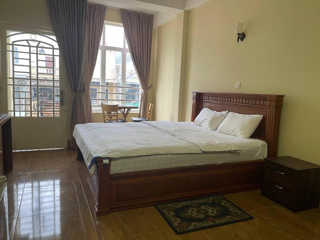 a bedroom with a large bed and a window at BLUE SKY GUEST HOUSE in Phnom Penh