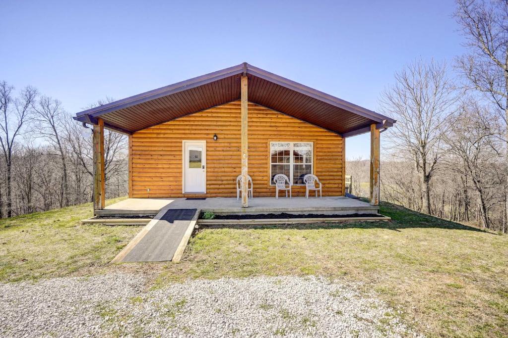 a log cabin with two chairs and a porch at Racine Vacation Rental 25 Mi to Athens! in Racine