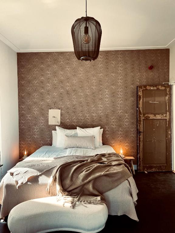 Postel nebo postele na pokoji v ubytování Hotel het Oude Raadhuis