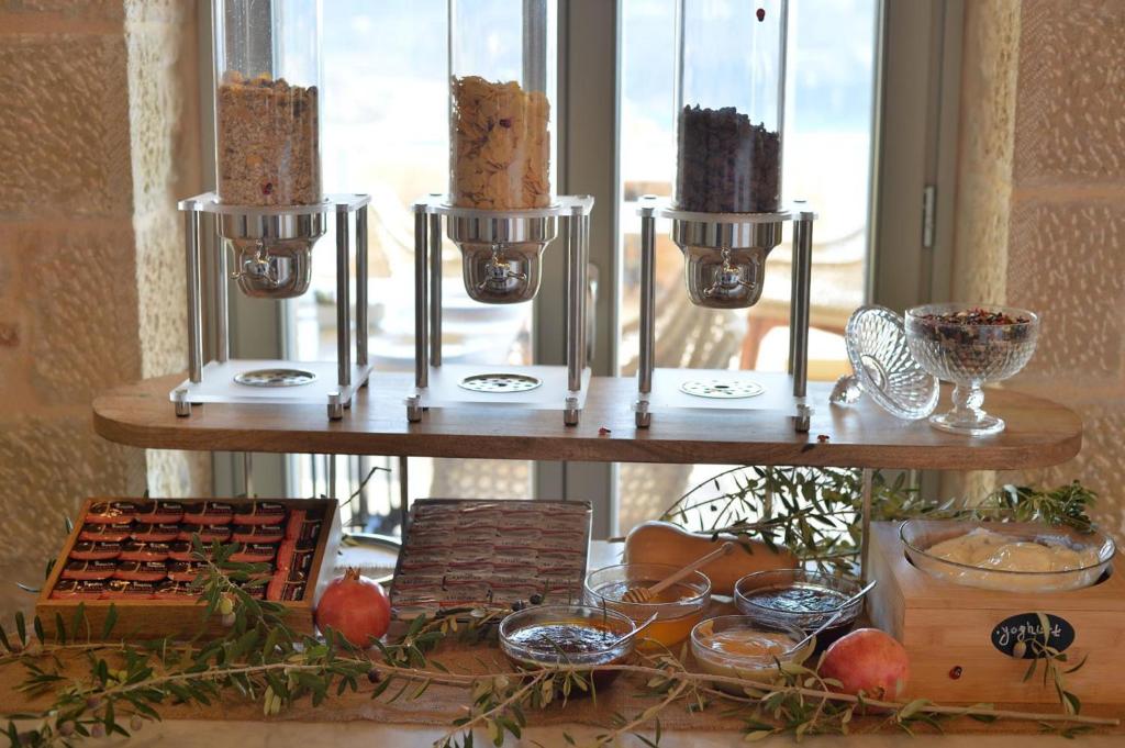 a table with cookies and other food on a shelf at Akrolithi Boutique Hotel & Suites in Oitylo