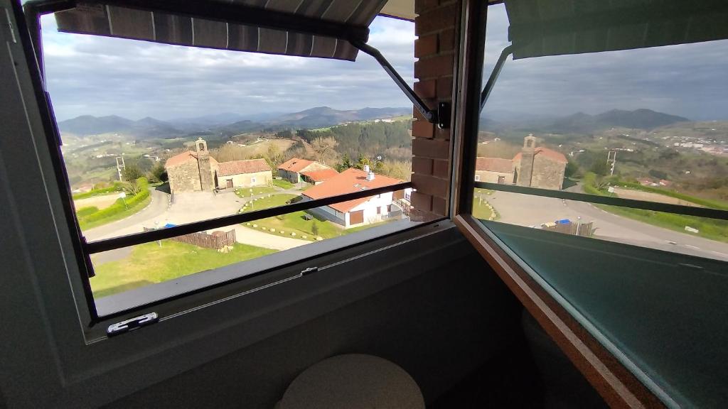 a view from a window of a house with mountains at Gazteategi in Zarautz