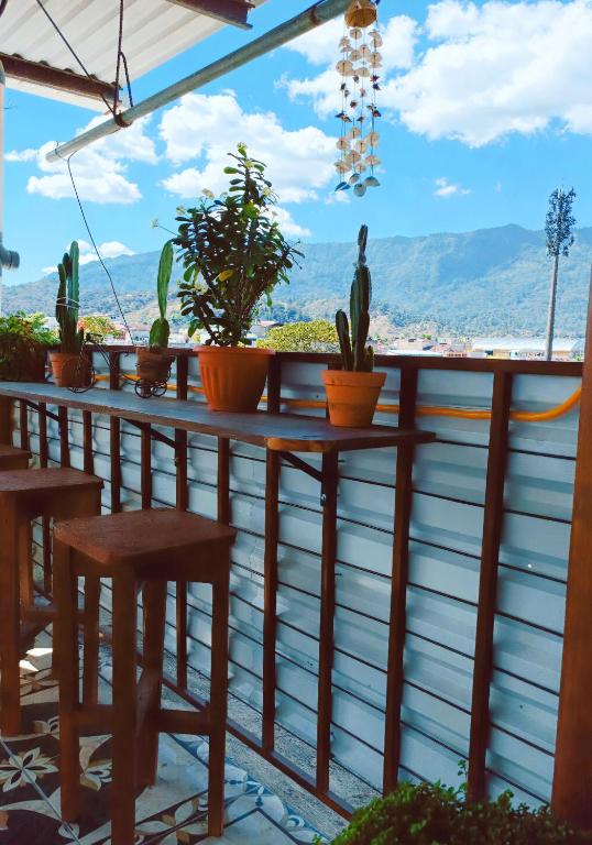 a table and chairs on a balcony with plants at Casas DiversA in Esquipulas