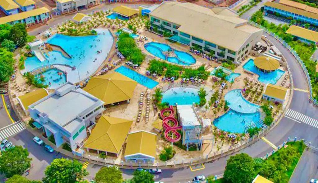 an aerial view of a resort with pools and umbrellas at Lacqua Di'Roma Parque - CN M in Caldas Novas