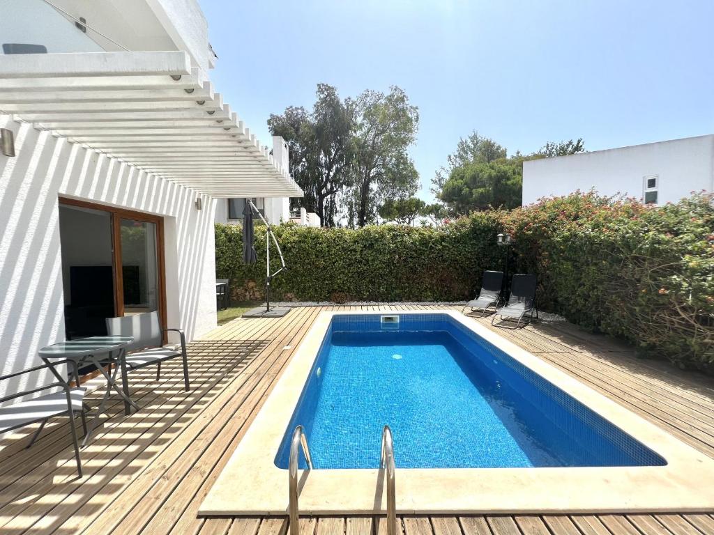 a swimming pool on a deck next to a house at Vila Ruby - Private Pool by HD PROPERTIES in Vilamoura