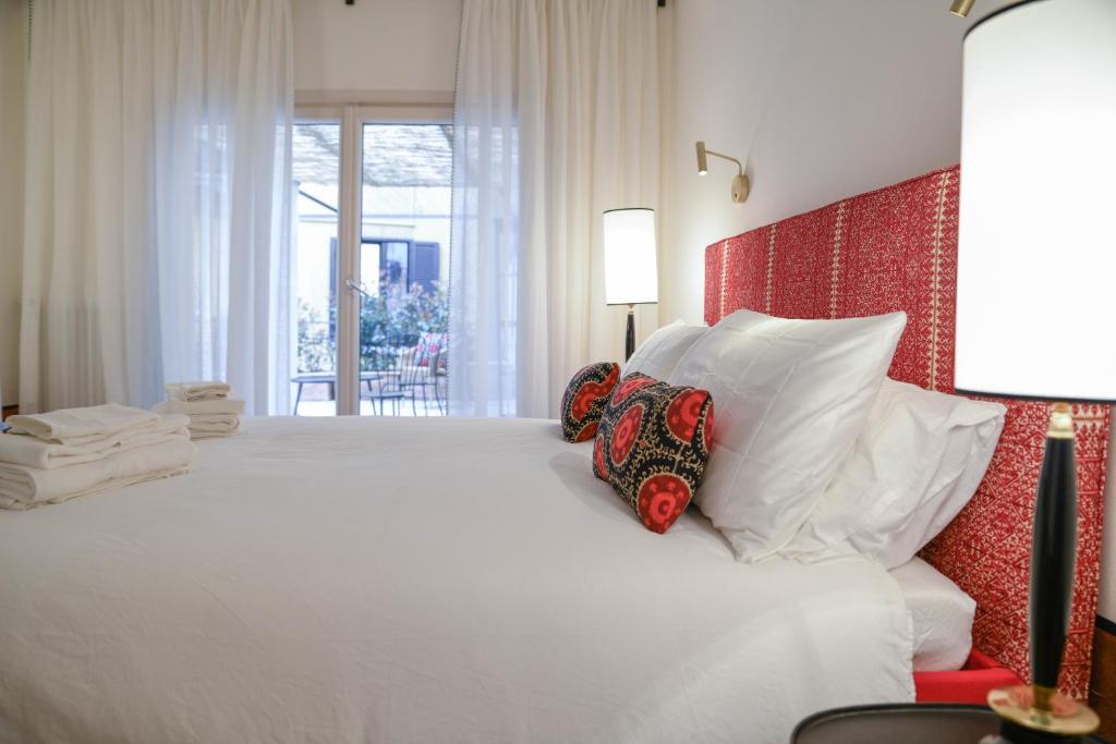 a bedroom with a large white bed with pillows at Residenza Radetzky in Milan