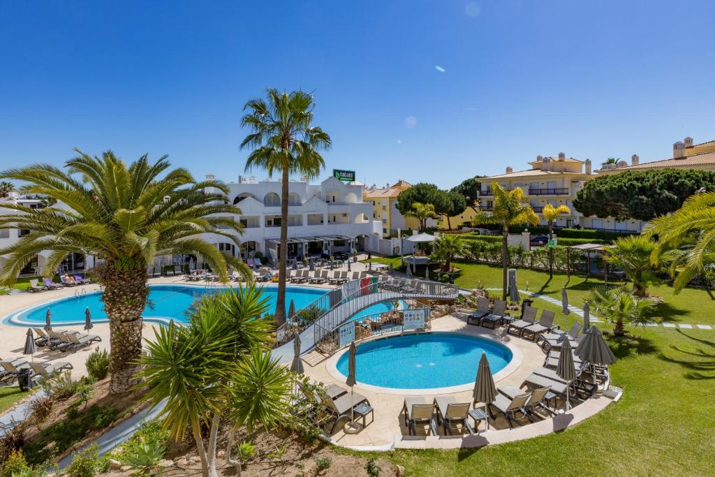 an aerial view of a resort with a pool and palm trees at Natura Algarve Club in Albufeira