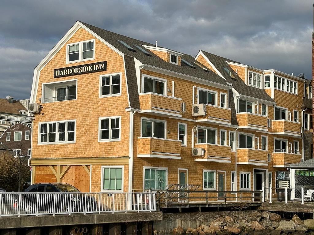 a building with balconies on the side of a river at Harborside Inn in Newport
