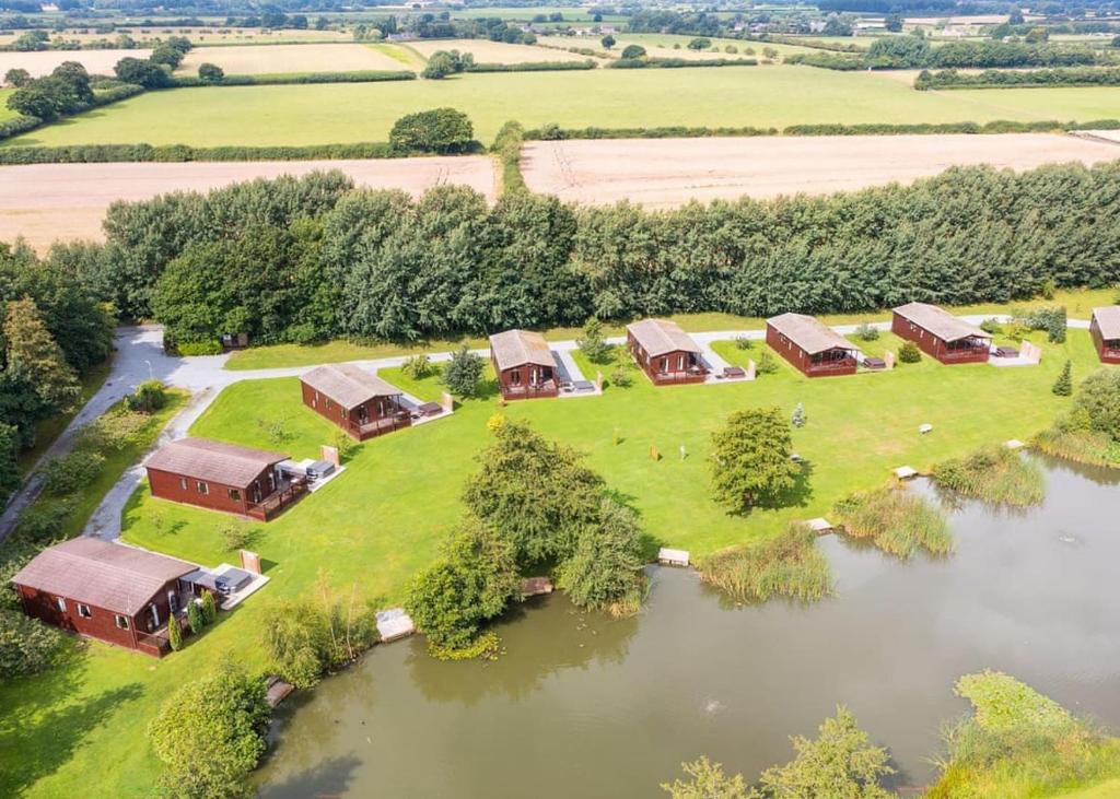 an aerial view of a house on an island in a lake at Paradise Lakeside Lodges in Wheldrake