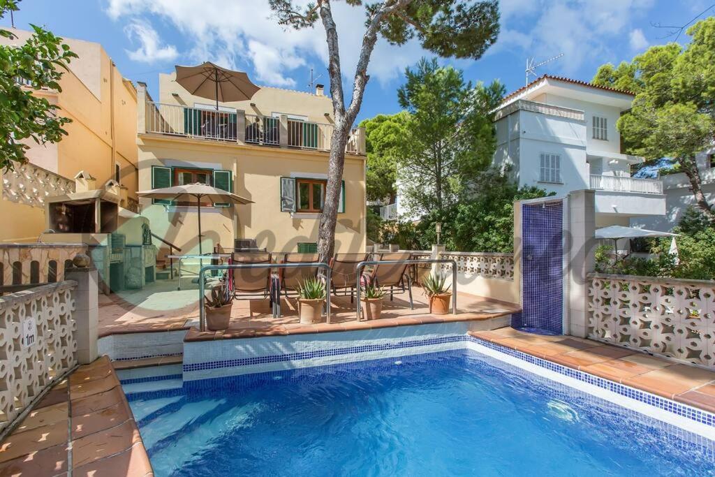 a swimming pool in front of a house at Villa Casablanca near port adriano by villasmediterranean in El Toro
