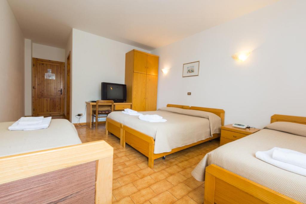 Postel nebo postele na pokoji v ubytování Albergo Dalla Mena