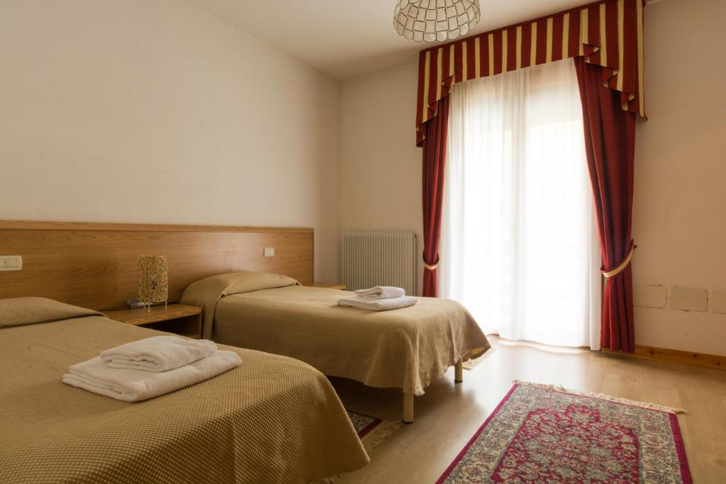 Postel nebo postele na pokoji v ubytování Albergo Dalla Mena