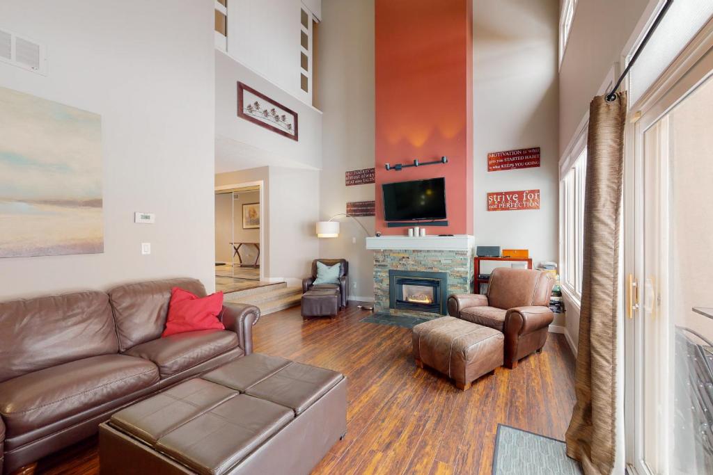 a living room with a couch and a fireplace at Wintergreen 125 in Blue Mountains