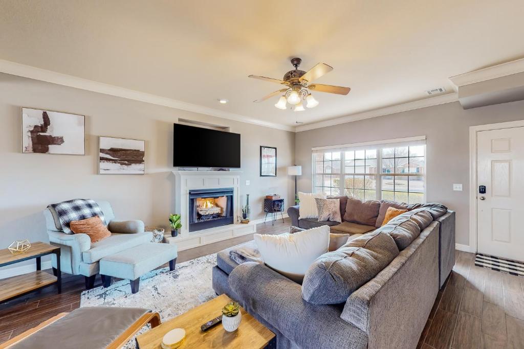 a living room with a couch and a fireplace at The Brick Beauty on Cabriolet in Bentonville