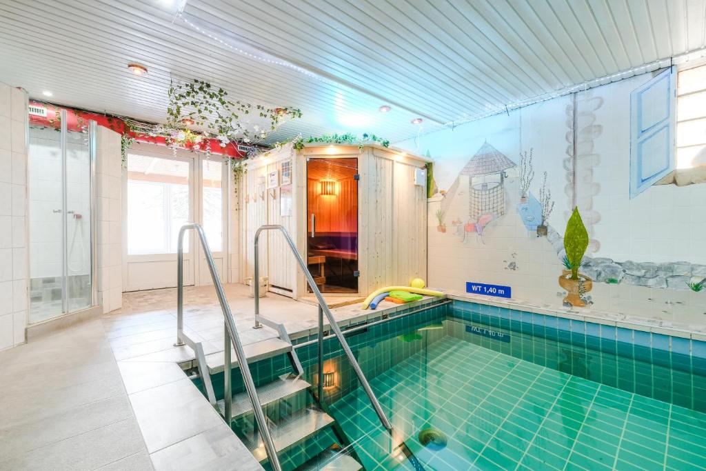 a swimming pool in a house with a swimming pool at Hotel Paidion in Braunlage