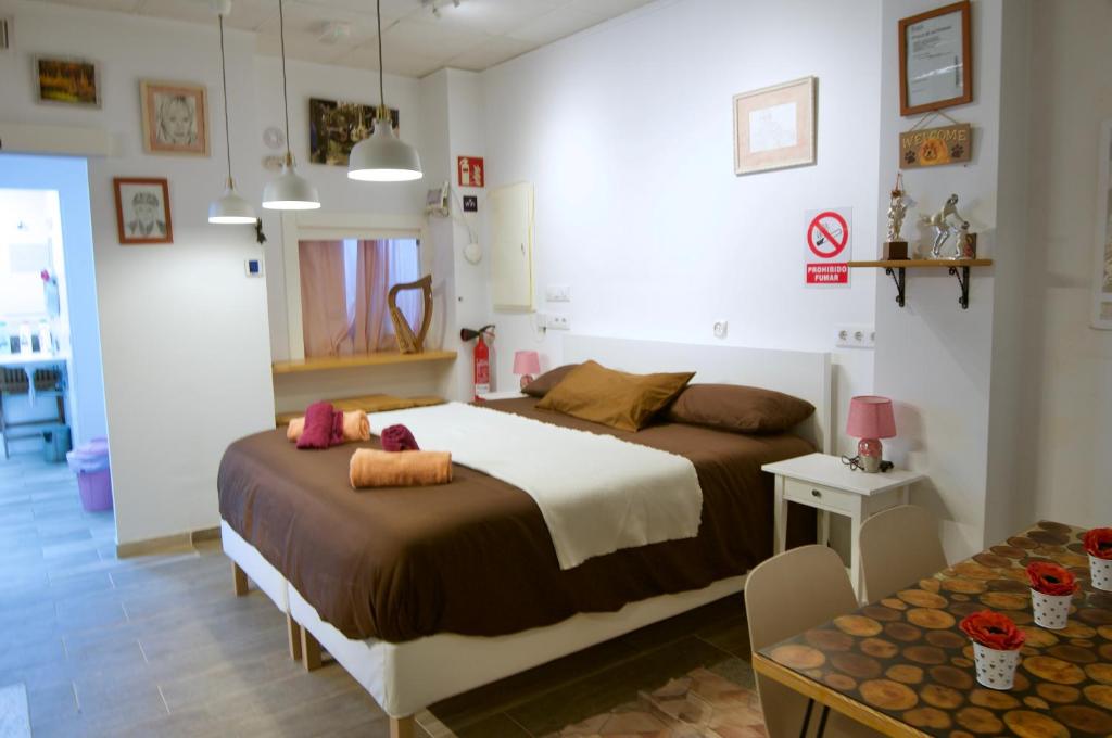 a bedroom with two beds and a table at Lux Valentia Olta Calpe in Calpe