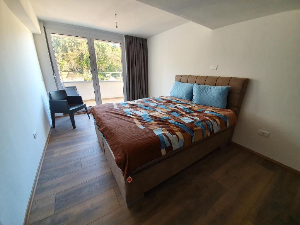 a bedroom with a bed in a room with a window at TopFloor Ohrid in Ohrid