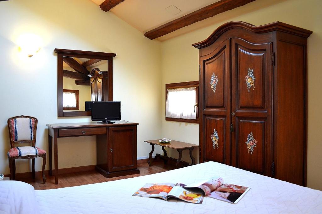 Postel nebo postele na pokoji v ubytování Albergo Minuetto