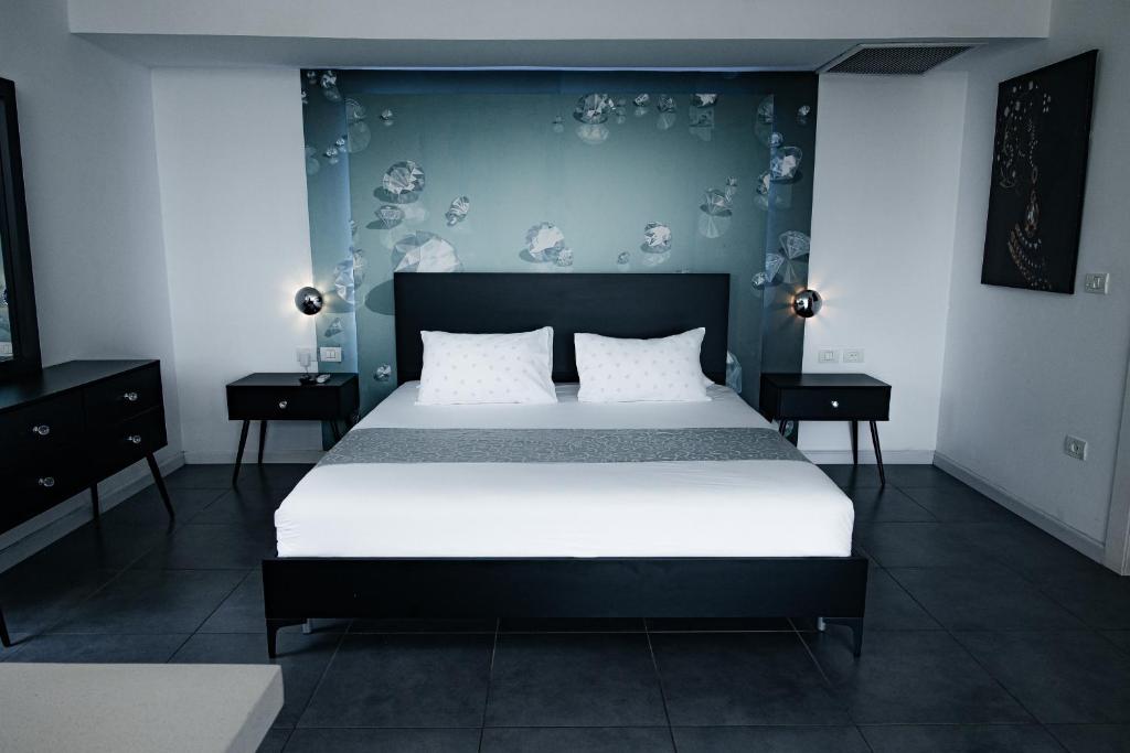 a bedroom with a large bed with a blue wall at BigPool - Diamond Mansion in Had Nes