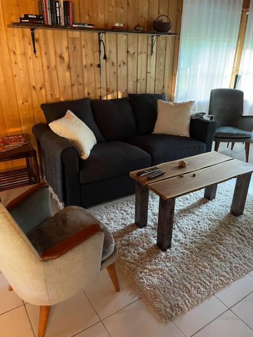 a living room with a couch and a coffee table at Majatalo Wanha-Pirtti in Iitti