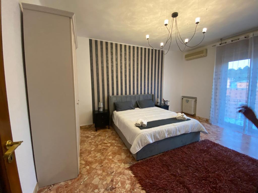 a bedroom with a bed and a large window at Labanca’s Home in Matera