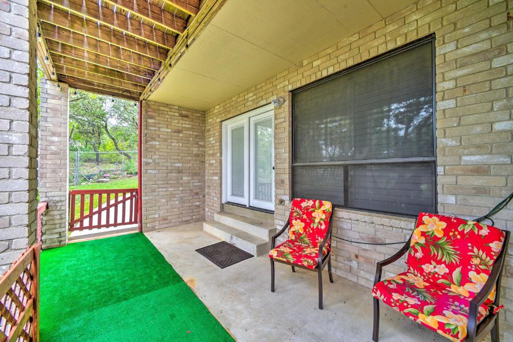 a porch with two chairs and a window at Relaxing Helotes Pad 7 Mi to UT at San Antonio! in San Antonio