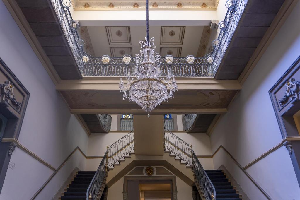 a chandelier hangs from the ceiling of a building at Palacio Julio Hotel in Puebla