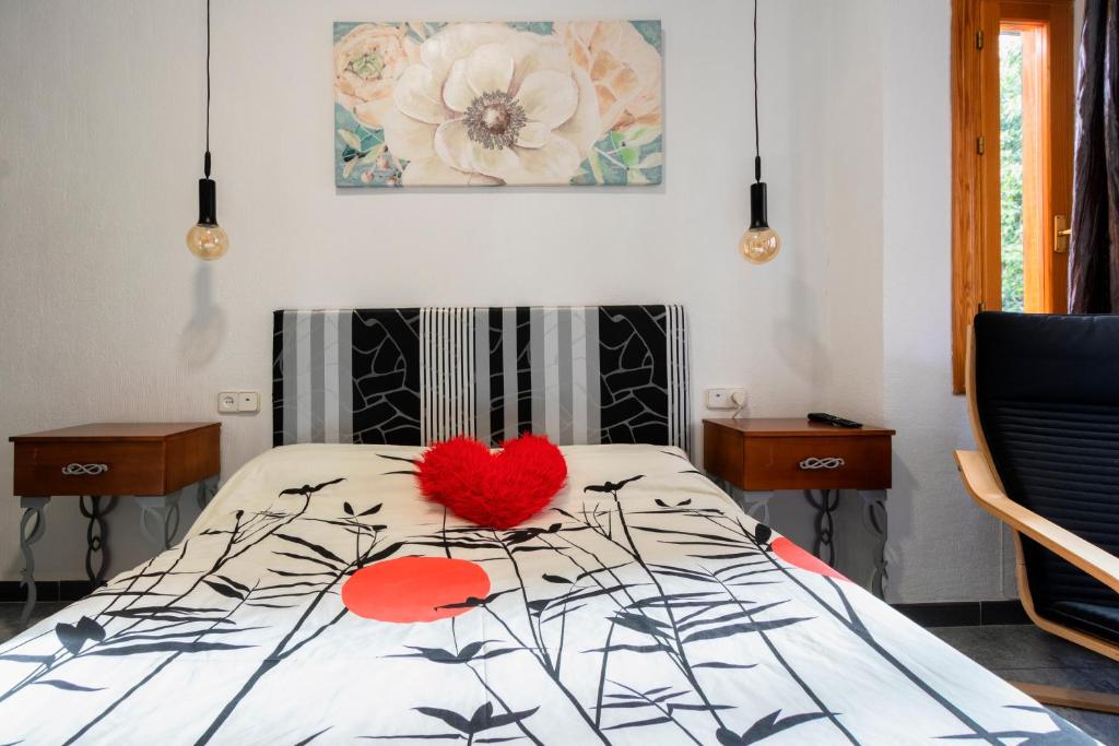 a bedroom with a bed with a red heart on it at Kings House in Almería