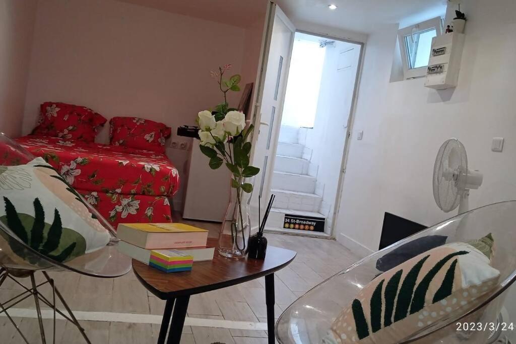 a living room with a red couch and a table at Superbe et vaste Logement(F) avec WIFI Gratuit in Drancy