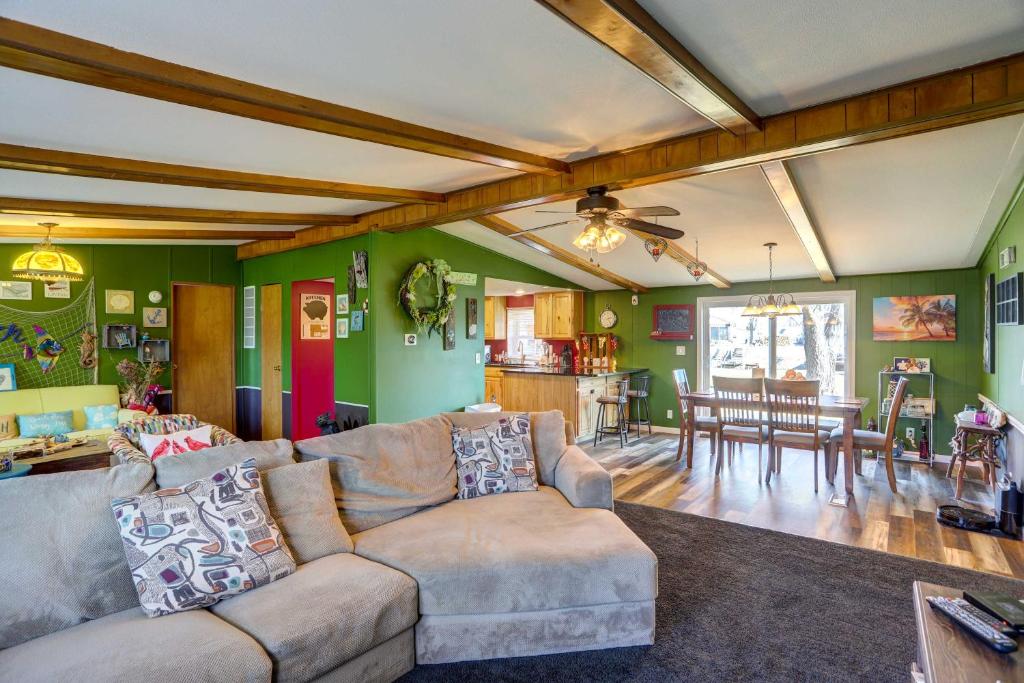 a living room with a couch and a dining room at Port Clinton House with Boat Dock on Portage River! in Port Clinton