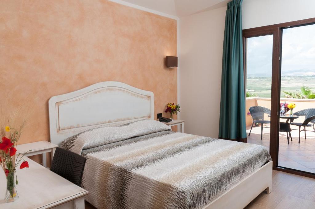 a bedroom with a bed and a balcony at Hotel Donna Carmela Sede Unica a Sciacca in Sciacca