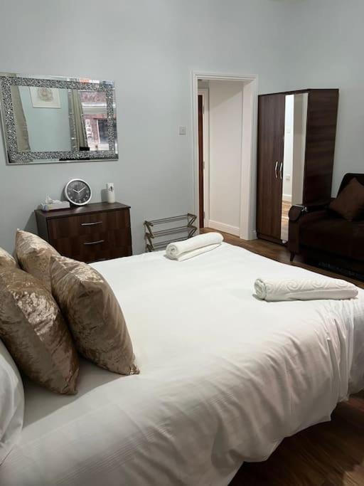 a white bed with two pillows on top of it at 020- S3 Excellent central location in Paddington in London