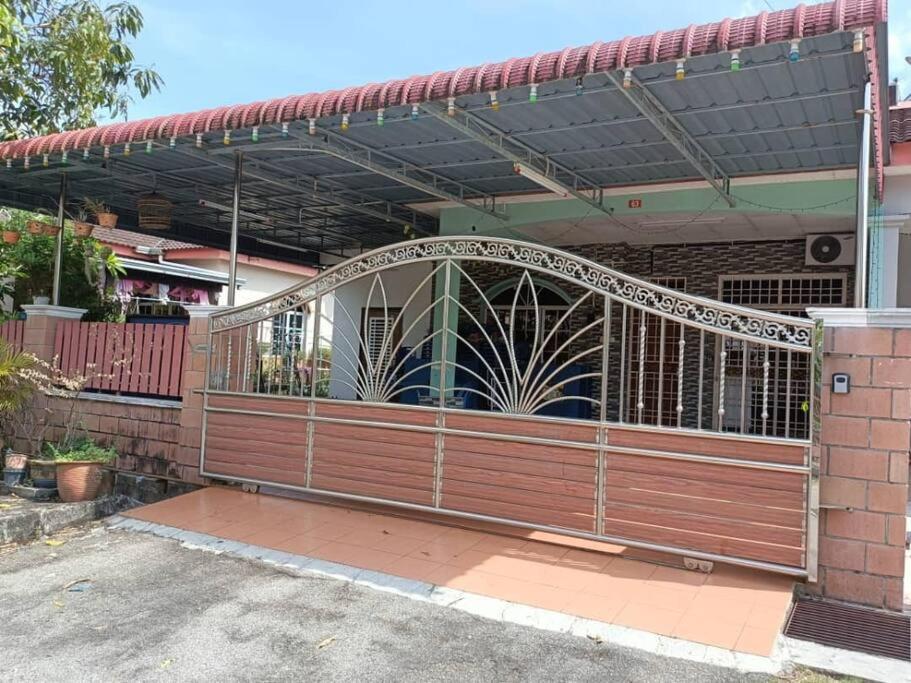 a gate in the front of a house at AlFateh Homestay Kepala Batas in Kepala Batas